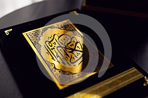Holy Quran book cover. black and gold design. arabic calligraphy. islamic symbol