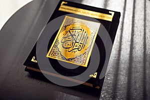 Holy Quran book cover. black and gold design. arabic calligraphy. islamic symbol