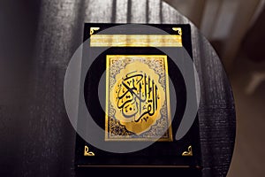 Holy Quran book cover. black and gold design. arabic calligraphy. islamic symbol