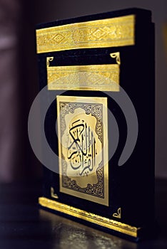 Holy Quran book cover. black and gold design. arabic calligraphy. islamic symbol