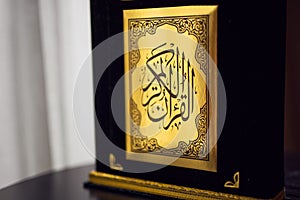 Holy Quran book cover. black and gold design. arabic calligraphy. islamic symbol