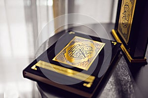 Holy Quran book cover. black and gold design. arabic calligraphy. islamic symbol