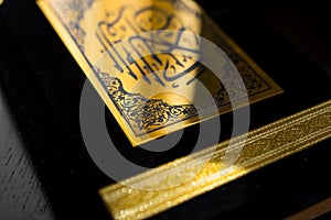 Holy Quran book cover. black and gold design. arabic calligraphy. islamic symbol