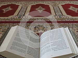 The Holy Quran in English and Arabic on a beautiful Eastern-Pattern Styled Rug photo
