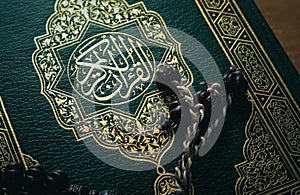 Holy Quran, Islamic Book Koran with rosary on Wood Background, Islamic Holy Quran and Subha with Soft Light
