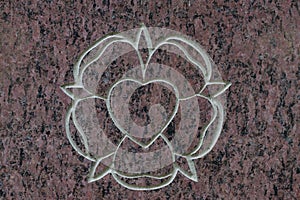 Holy rose and sacred heart on stone surface. Symbol of the holy spirit.