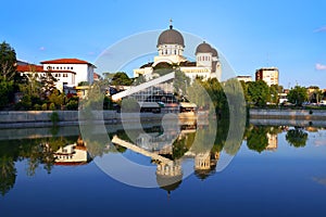 The `Holy Trinity` Orthodox Cathedral from Arad  mirrored in the lake water from the Padurice park.