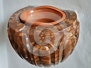 Holy water bowl made of marble with a remnant of water consecrated by the priest