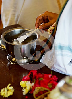 Holy water or coconut water in a vessel given to devotees by priest in a hindu temple