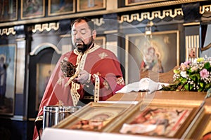 Holy water consecration in orthodox church. Religious priest during service photo