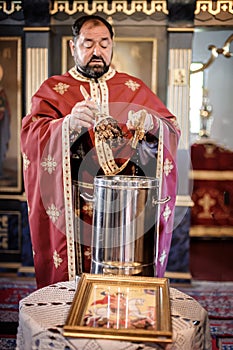 Holy water consecration in orthodox church. Religious priest during service photo