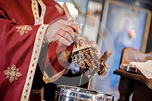 Holy water consecration in orthodox church. Religious priest during service photo