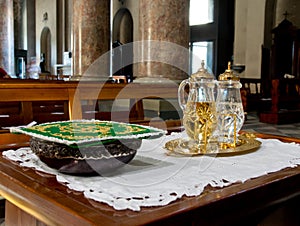 Holy water and holy wine ready for mass