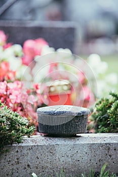 Holy water in iron bowl, cemetery, flowers