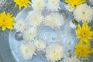 Holy water in silver bowl of buddhism in temple at thailand yellow and white