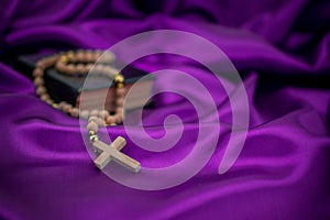 Holy week Bible rosary beads on purple background
