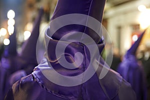 Holy week, easter time in Spain. Nazarenos in purple dress photo