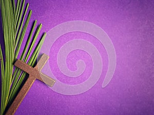 Holy Week, Lent, Palm Sunday, Good Friday, Easter Sunday Concept. Cross shaped and palm leaf in purple background with copy space.