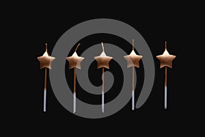 Holydays star shaped candles isolated on a black background. Merry Christmas and Happy New Year photo