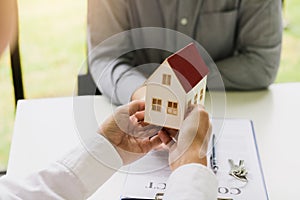 Home agents are giving house gifts to new home buyers in office room