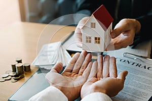 Home agents are giving house gifts to new home buyers in office room