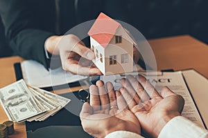 Home agents are giving house gifts to new home buyers in office room