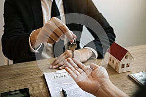 Home agents are handing out keys to home buyers who are signing contracts at the office