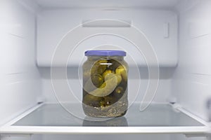 Home appliance - Can with cucumbers in open white refrigerator