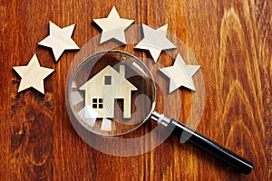 Home appraisal. House with magnifying glass and five star photo