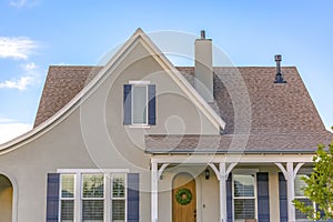 Home with arched front door and reflective windows