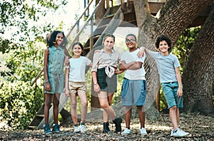 A home away from home. Shot of a group of teenagers standing next to a tree at summer camp.