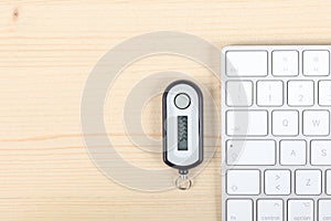 Home banking password generator on a wooden desk, a computer keyboard with copy space for your text