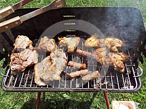 Home barbaque grill with grilled meat close up