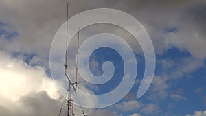 Home based dual spike Telecommunications antenna tower with storm clouds time lapse