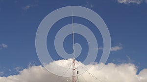 Home based single spike Telecommunications antenna tower heavy clouds day time lapse