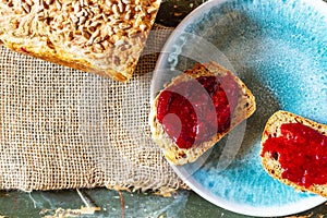 Home breakfast. A quick breakfast. Coffee and sandwich. Jam sandwich. Self-made bread. Raspberry jam .