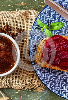 Home breakfast. A quick breakfast. Coffee and sandwich. Jam sandwich. Self-made bread. Raspberry jam .