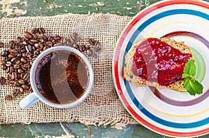 Home breakfast. A quick breakfast. Coffee and sandwich. Jam sandwich. Self-made bread. Raspberry jam .