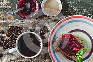 Home breakfast. A quick breakfast. Coffee and sandwich. Jam sandwich. Self-made bread. Raspberry jam .