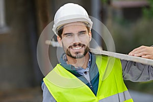 home builder carrying wood