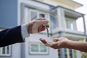 Home buyers are taking home keys from sellers. Sell your house, rent house and buy ideas photo