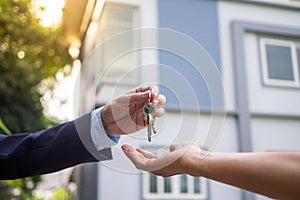 Home buyers are taking home keys from sellers. Sell your house, rent house and buy ideas photo