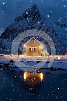 Home, cabin or house at night, Norwegian fishing village in Reine City, Lofoten islands, Nordland county, Norway, Europe. White