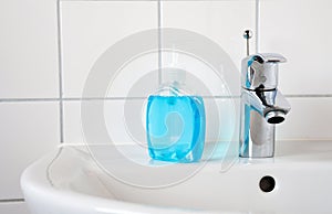 Home care image bathroom washbaisn ,tab water with a bottle blue gel alcohol sanitizers for washing hand for protect family from