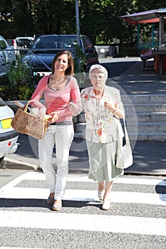 Home carer with elderly person in town