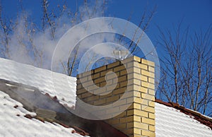 Home chimney smoke in the winter season