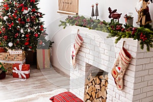 The Christmass tree stands near presents photo