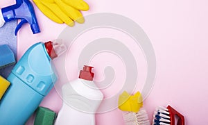 Home cleaning kit on a pastel pink background with space for text, top view