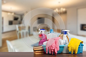 Home cleaning service concept with supplies. Close up of cleaning supplies in front of livingroom