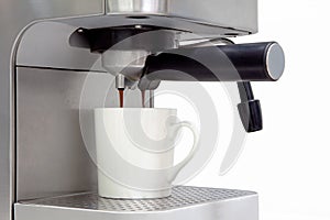 Home coffee machine making espresso on a white background with c